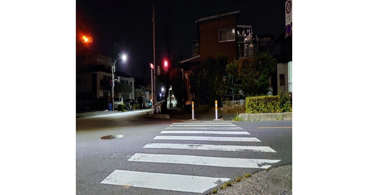 A bustling but orderly street crossing in Tokyo at night, raising the question of how safe Japan really is for tourists.