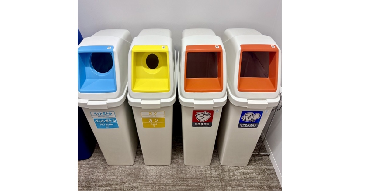 A row of neatly separated trash cans in Japan, illustrating the country's complex garbage sorting rules.